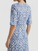 Blue and white ikat print maxi dress, angled back view.
